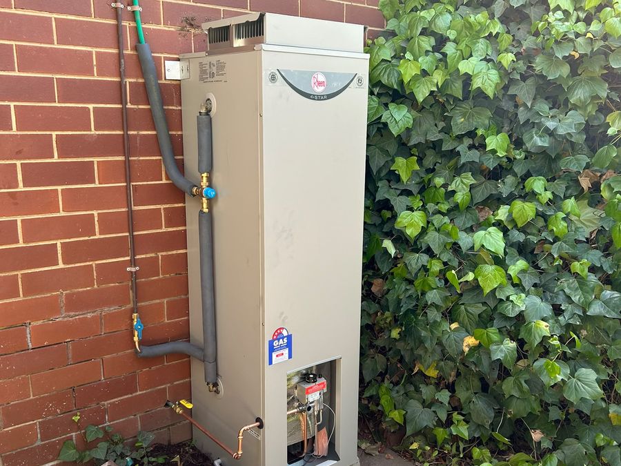 Storage hot water system installed against a brick wall in Melbourne